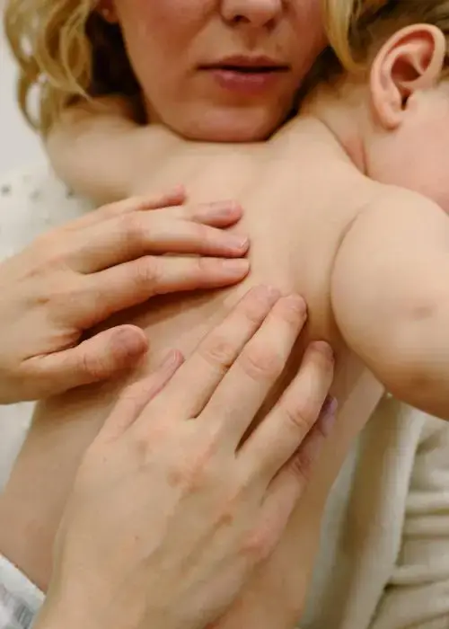 Chiropractor checking a toddler’s spinal health as part of pediatric chiropractic care.