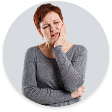 Woman experiencing jaw pain, representing chiropractic care for TMJ disorder