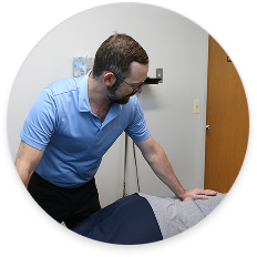 Chiropractor providing gentle, supportive care for a patient with osteoporosis in a clinical setting