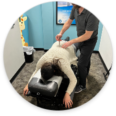 Chiropractor performing a gentle spinal adjustment on a patient in a clinical setting