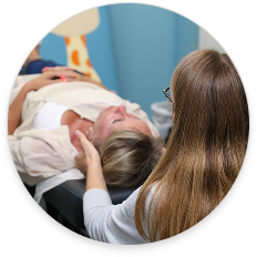Chiropractor providing gentle neck adjustment to a patient during a treatment session