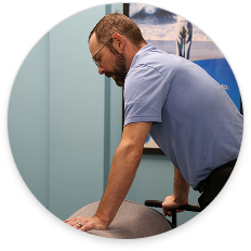 Chiropractor performing a gentle spinal adjustment for disc injury treatment in a clinical setting