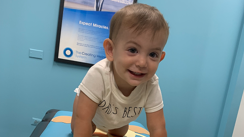 Infant receiving gentle chiropractic care, representing support for abdominal and digestive health