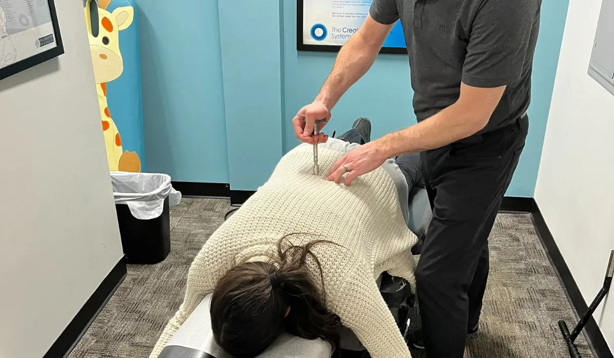 Chiropractor performing gentle spinal adjustment during new year with chiropractic care session in 2026.