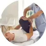 Doctor performing a chiropractic leg alignment to a man for his sport conditional therapy.