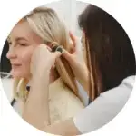 Doctor doing a ear checkup to a woman who is suffering a ear infection