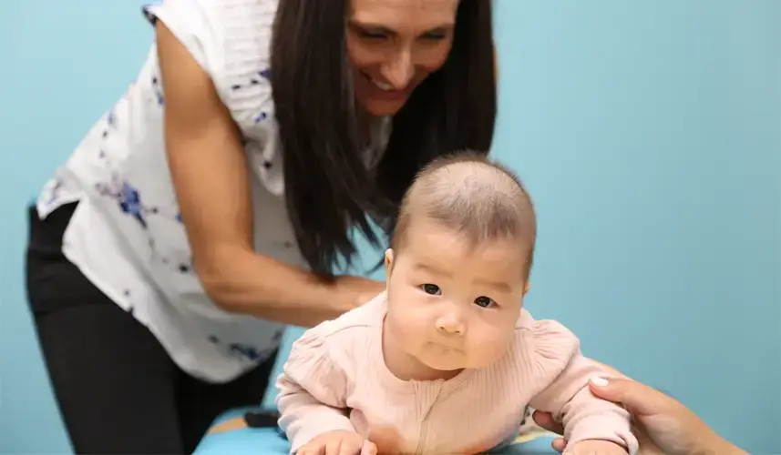 Chiropractor providing colic relief to a baby.