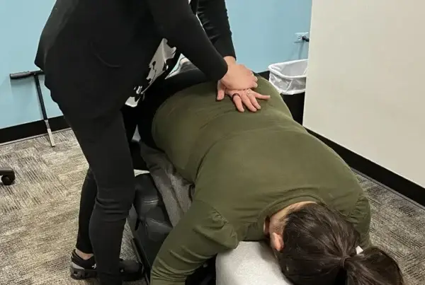 Chiropractic solutions: A woman getting her back adjusted.