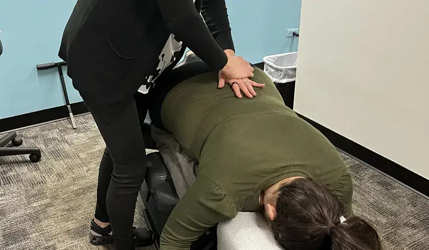 Chiropractic solutions: A woman getting her back adjusted.