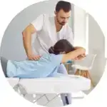 Doctor doing chiropractic therapy on woman's back to get rid of her back pain.