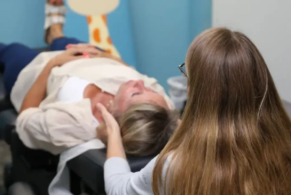 Chiropractor adjusts patient's upper cervical spine to relieve pain linked to TMJ and the spine misalignment.