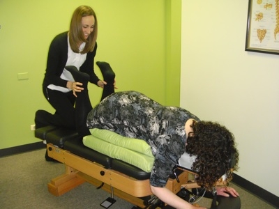 A woman receiving a chiropractic